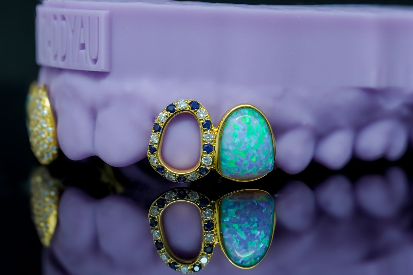 Luxury custom grillz featuring opal gemstone and sapphire diamond details set in gold by Drip Daddy.