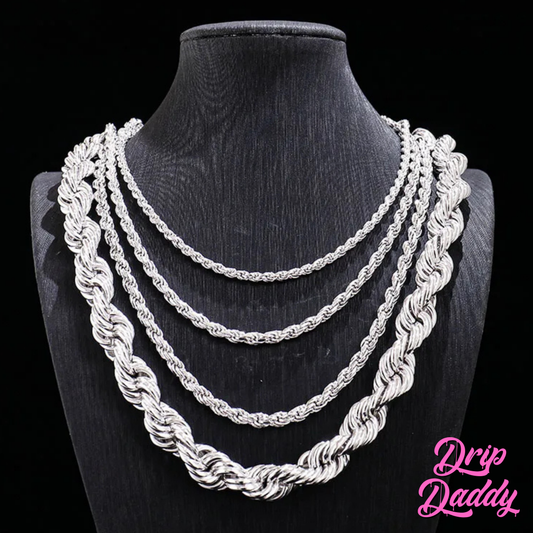 A black necklace bust showcases four Drip Daddy Classic Rope Chains (3mm–12mm, White Gold Plated) layered by thickness. The pink Drip Daddy logo is in the bottom right corner.