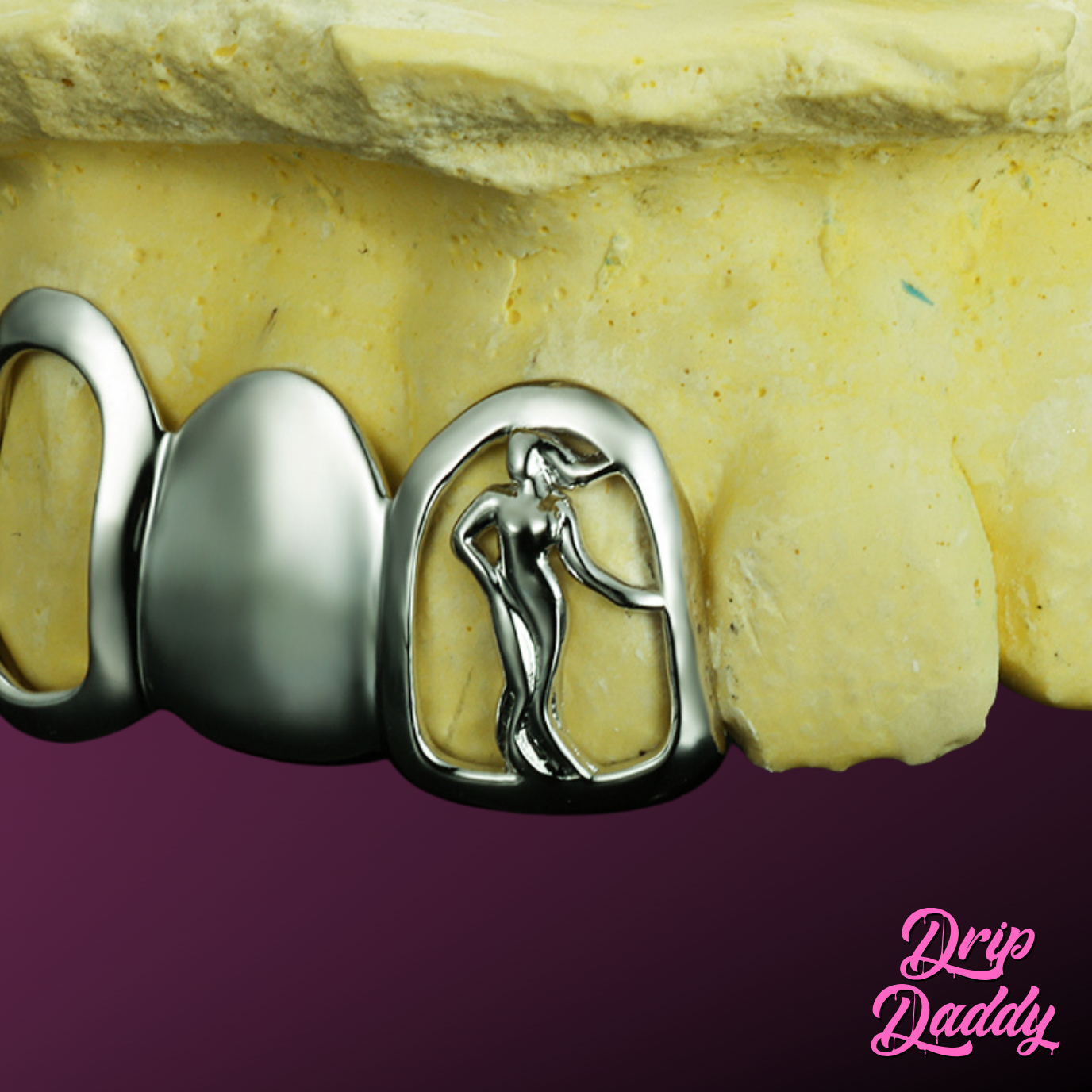Custom silver grillz with a cut-out silhouette object design on a tooth cap by Drip Daddy.