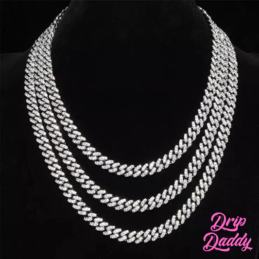 Close-up of Drip Daddy’s Frosted Miami Cuban Link Chain in 10mm, crafted in white gold plating with moissanite stones, displayed on a black mannequin bust in layered lengths, with the Drip Daddy logo in pink at the bottom right.