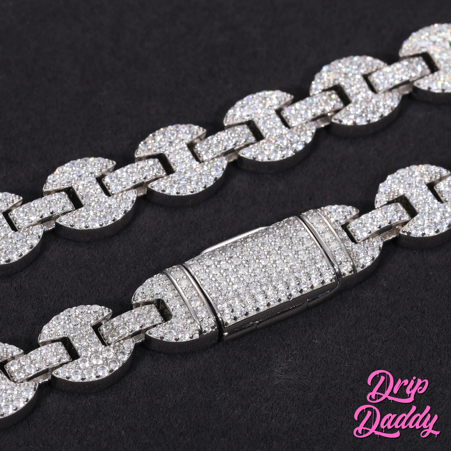 Detailed close-up of the clasp on Drip Daddy’s Gemlock Link chain in 6mm to 10mm size, crafted in white gold plating with moissanite stones, displayed on a black background with the Drip Daddy logo in pink at the bottom right.