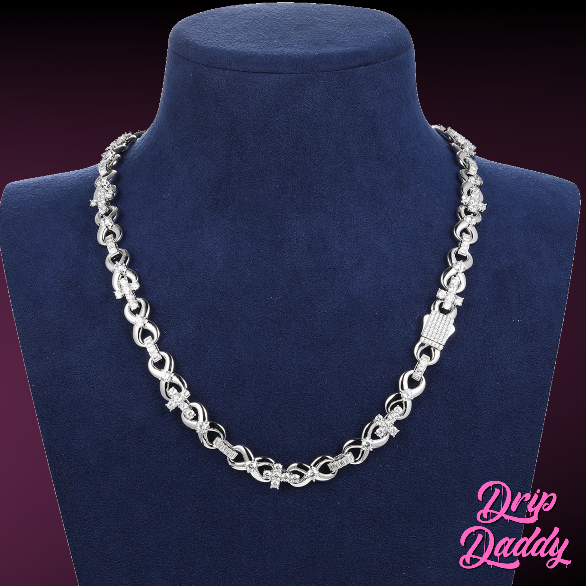 The Infinity Cross Plain – 10mm Mixed Link Chain in white gold by Drip Daddy, displayed on a blue mannequin bust. The Drip Daddy logo is seen in pink at the bottom right.