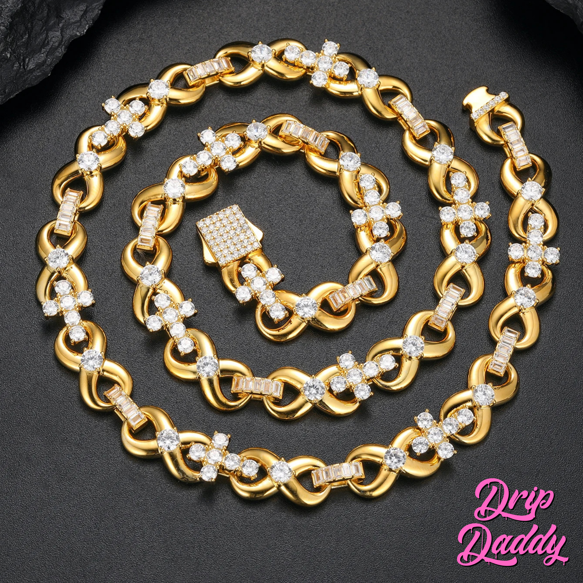 Drip Daddy’s Infinity Cross Plain – 10mm Mixed Link Chain in yellow gold, displayed coiled on a black surface with diamond details shining. The Drip Daddy logo is visible in pink at the bottom right.