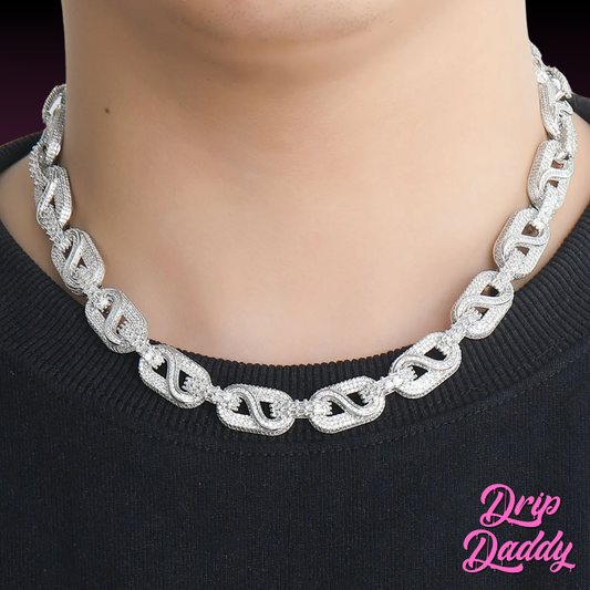 The Snowdrift – 14mm Baguette & Round Moissanite Link Chain by Drip Daddy in white and yellow gold plating, worn around the neck against a black shirt.