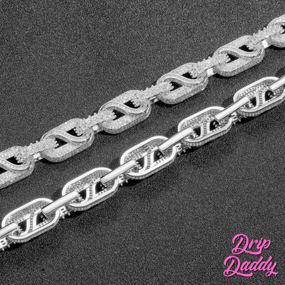 Two Snowdrift chains by Drip Daddy – 14mm baguette and round moissanite iced-out link necklaces in white and yellow gold plating, displayed side by side on a black surface.