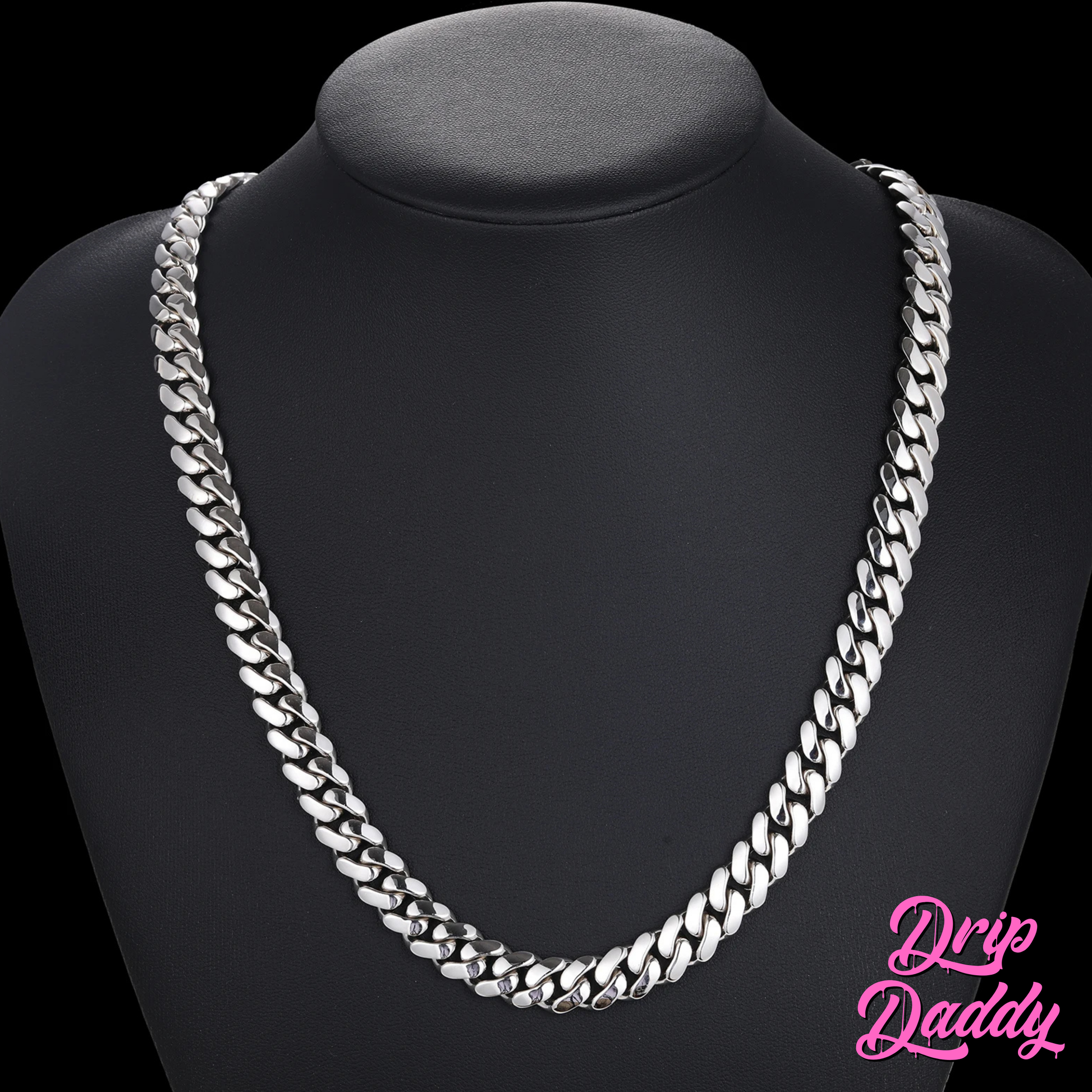 A display bust showcasing Drip Daddy’s The Classic Miami Cuban Link Chain in white gold plated finish, photographed on a matte black mannequin bust with a clean black background, with the Drip Daddy logo in pink at the bottom right corner.