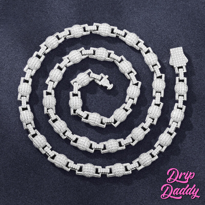 Close-up of Drip Daddy’s The Juggernaut – 7mm Moissanite Bead Link Chain in white gold plating, arranged in a spiral on a dark textured background with the Drip Daddy logo in pink at the bottom right.