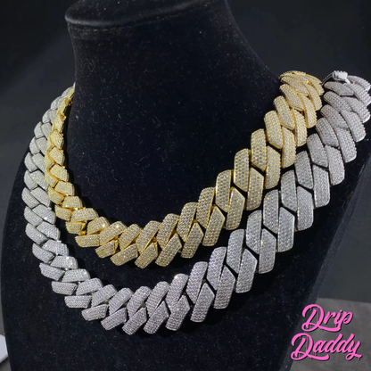 Close-up of Drip Daddy’s The Power Link Cuban chains in 20–27mm, featuring both white gold plated and yellow gold plated moissanite styles, displayed layered on a black velvet bust. The Drip Daddy logo in pink is visible in the bottom right corner.