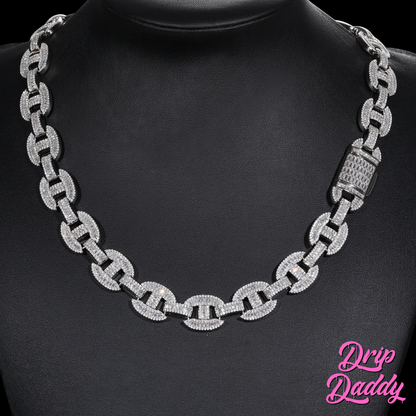 The Drip Daddy G-Link – 16mm Baguette Moissanite Chain is displayed on a black mannequin bust, showing its full white gold design with a fully iced clasp. The Drip Daddy logo appears in pink at the lower right corner.