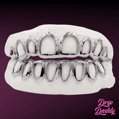 Custom Open Face Window Grillz in rhodium-plated 925 sterling silver, full upper and lower set on a dental mold, shown on a purple gradient with the Drip Daddy logo.