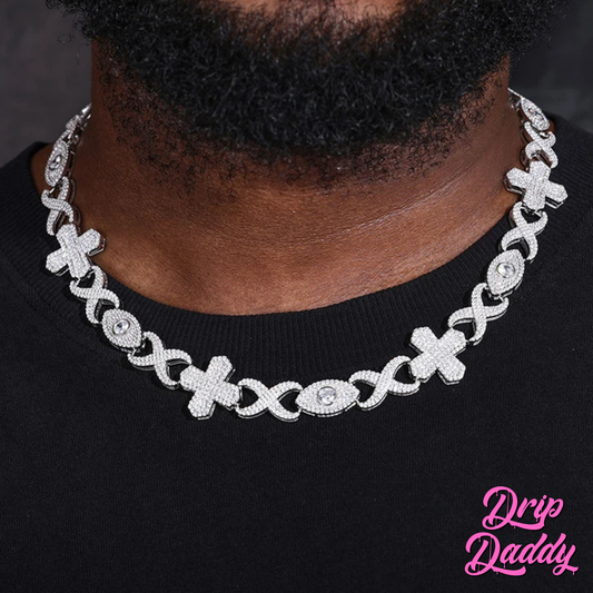 A model wearing the Drip Daddy Evil Eye Cross Link – 12mm Moissanite Chain in white gold, styled on a black shirt, highlighting the bold iced-out cross and eye-shaped links.
