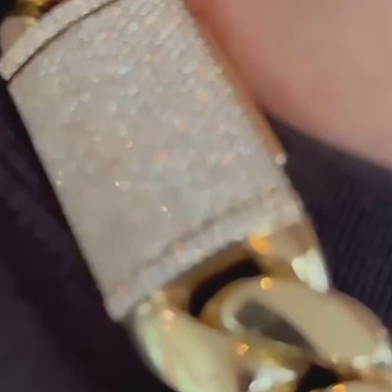 A person wearing Drip Daddy’s The Don – 20mm to 30mm Miami Cuban Link Chain in polished white and yellow gold plating, shown in a lifestyle model video. The chain is thick and bold, capturing light with its reflective surface and heavyweight design. The Drip Daddy logo in pink is displayed in the corner of the video frame.