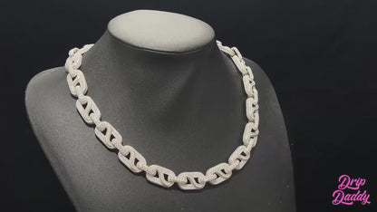 A cinematic showcase of The Snowdrift – 14mm Baguette & Round Moissanite Link Chain by Drip Daddy. The iced-out chain sparkles under studio lighting, highlighting baguette and round moissanite stones with a secure clasp.
