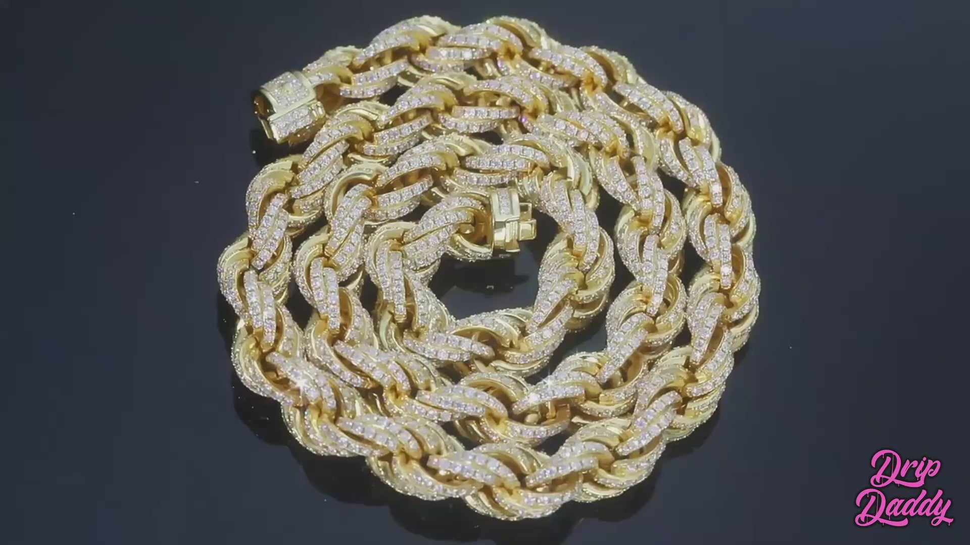 Close-up video of Drip Daddy’s Avalanche Rope – 8mm to 14mm Moissanite Rope Chain in yellow gold and white gold plating, slowly rotating under studio lighting to highlight the detailed rope design and iced-out moissanite stones. The chains shimmer as the camera pans smoothly, emphasizing their luxurious shine and texture. The Drip Daddy logo in pink is visible in the corner throughout the video.