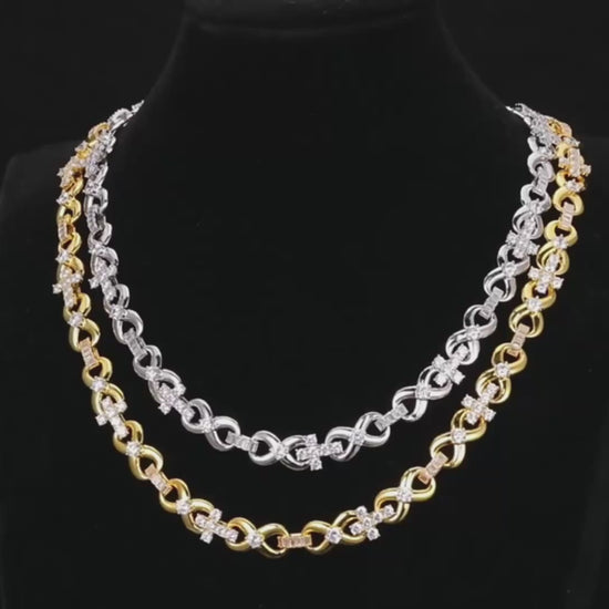 A studio-lit video showcasing Drip Daddy’s The Infinity Cross Plain Chain. The camera pans across the chain, highlighting its polished finish and clean design against a dark background, with the Drip Daddy logo visible in the corner.