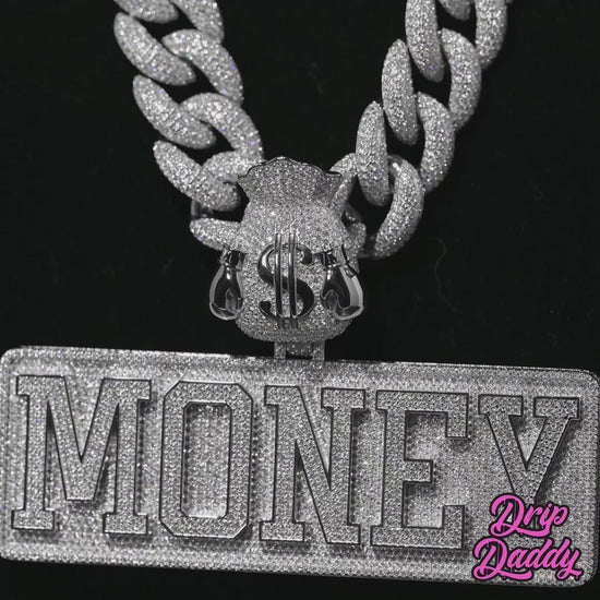 Rotating video of a custom MONEY pendant with moissanite stones set in sterling silver and white gold plating, designed for luxury streetwear jewelry style.