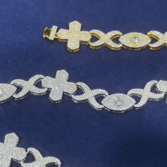 Promotional video of the Drip Daddy Evil Eye Cross Link – 12mm Moissanite Chain, rotating views in yellow gold and white gold, showing intricate cross and eye link design under studio lighting.