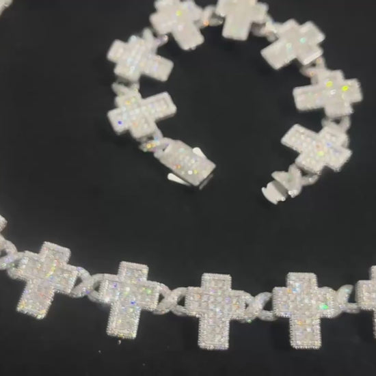 Close-up product video of the Crucifix Link chain in 8mm, iced with moissanite stones. The luxury necklace features crucifix-style links with brilliant sparkle under studio lighting, showcasing premium craftsmanship, white gold plating, and high-end iced-out jewelry design.