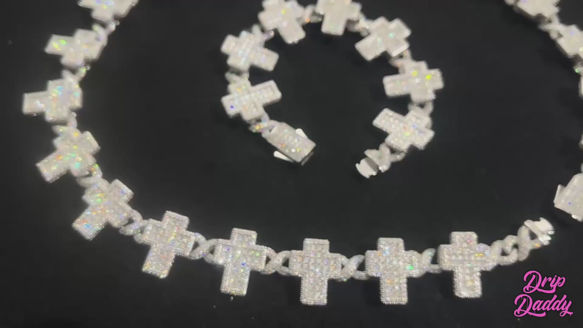 Close-up product video of the Crucifix Link chain in 8mm, iced with moissanite stones. The luxury necklace features crucifix-style links with brilliant sparkle under studio lighting, showcasing premium craftsmanship, white gold plating, and high-end iced-out jewelry design.