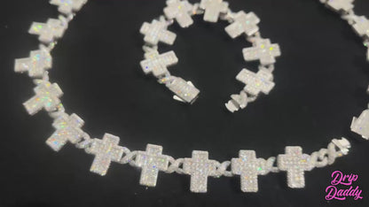 Close-up product video of the Crucifix Link chain in 8mm, iced with moissanite stones. The luxury necklace features crucifix-style links with brilliant sparkle under studio lighting, showcasing premium craftsmanship, white gold plating, and high-end iced-out jewelry design.