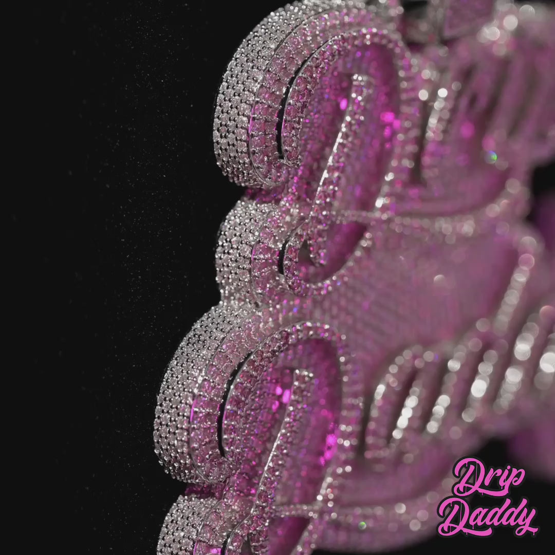 Close-up video of a custom Drip Daddy pendant in 925 sterling silver with white gold plating and moissanite stones, showcasing luxury custom jewelry design.