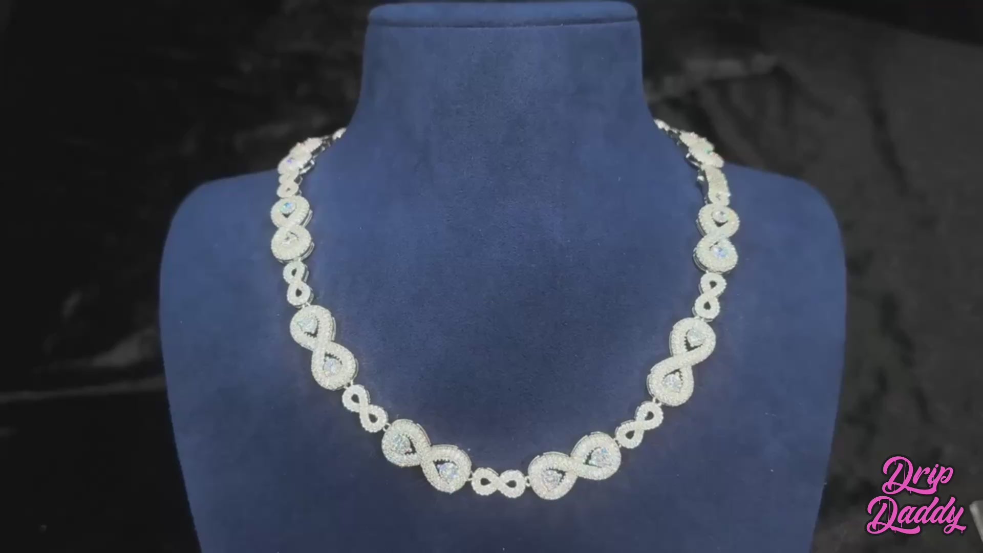 Video of the Eternal Drip – 12mm Moissanite Chain, showing a close-up of the chain under studio lighting. The camera pans smoothly across the links, highlighting the precision-set moissanite stones and their high sparkle. The white gold plated finish reflects light with a polished shine, giving the chain a luxurious, icy look