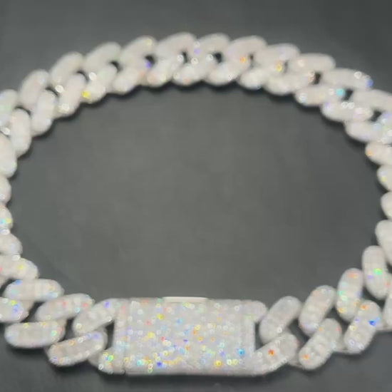 A rotating product video of Drip Daddy’s Capsule – Mixed-Cut Cuban Chain in yellow gold plating. The camera highlights the alternating round and emerald-cut moissanite stones set into the links, showing the shimmer and craftsmanship from multiple angles. The Drip Daddy logo is displayed in pink at the bottom right.